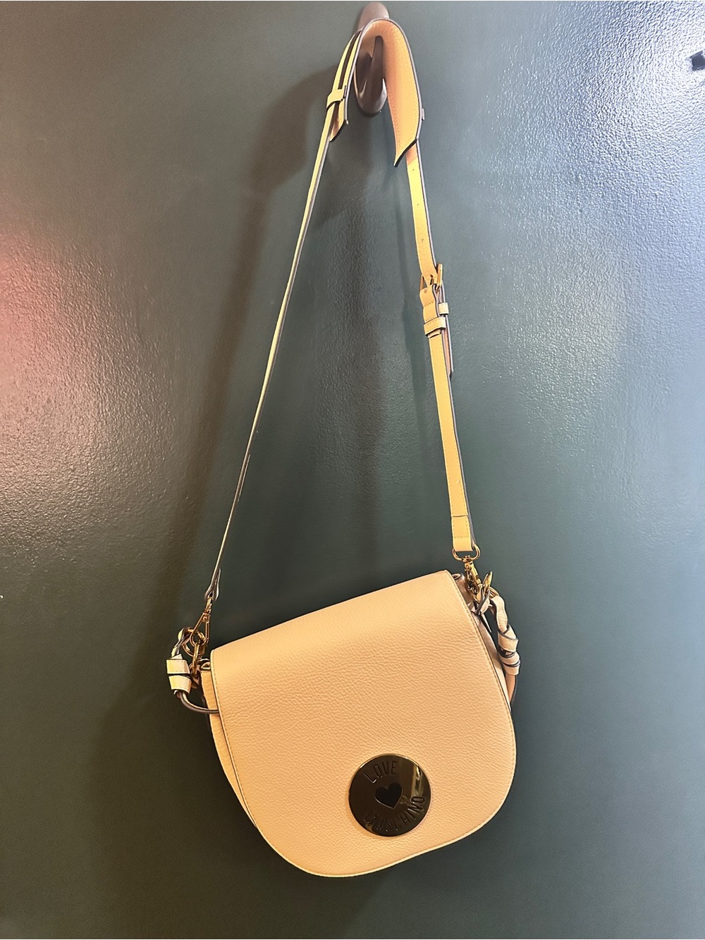 Love Moschino Cream Pebbled Leather Shoulder Saddle Bag with Gold Medallion